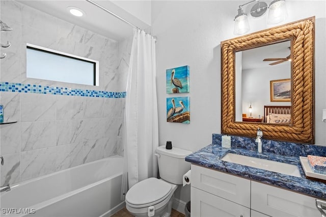 full bathroom featuring shower / tub combo, vanity, toilet, and ceiling fan