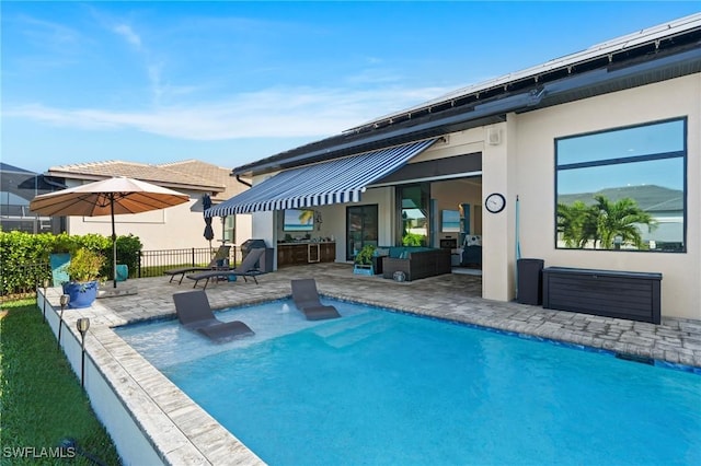 rear view of property featuring outdoor lounge area