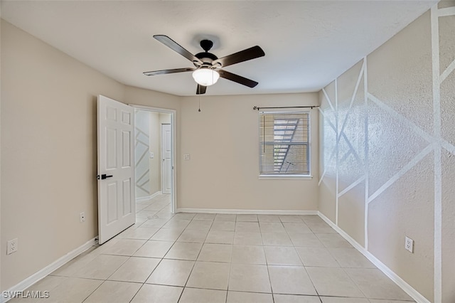 tiled empty room with ceiling fan