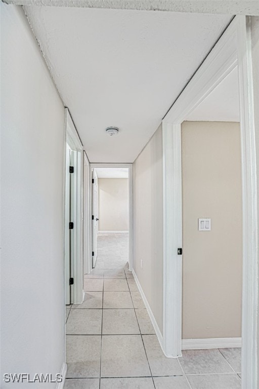 hallway featuring light tile patterned floors