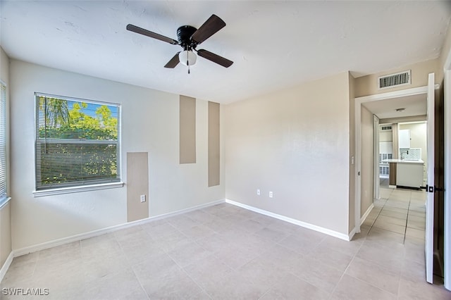 unfurnished room featuring light tile patterned floors and ceiling fan