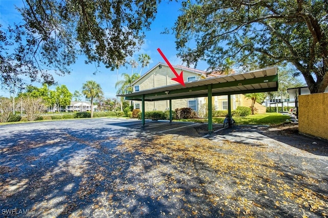 view of vehicle parking with a carport