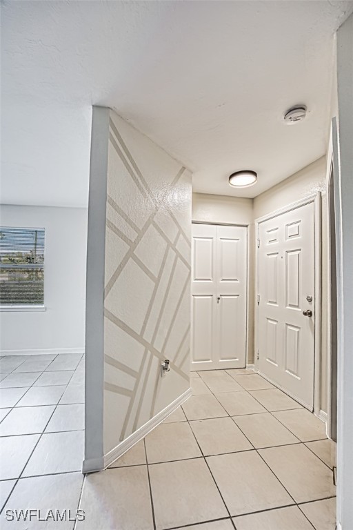 hall featuring light tile patterned flooring