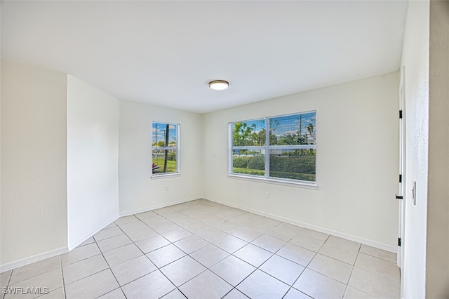 unfurnished room featuring light tile patterned floors