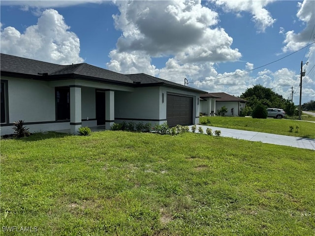 view of home's exterior with a garage and a lawn