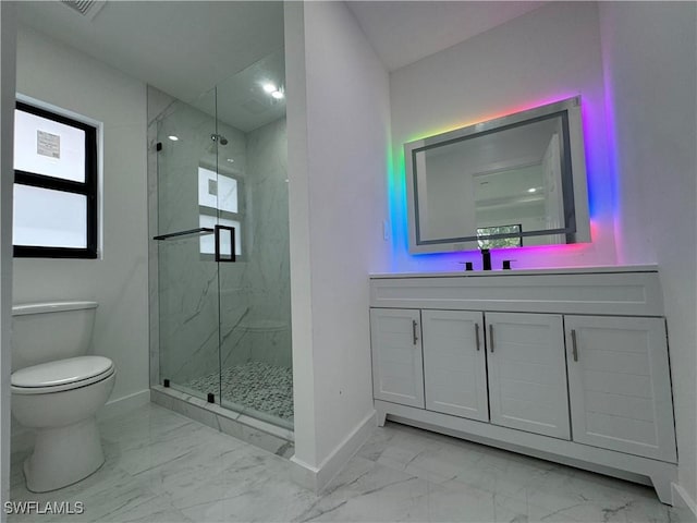 bathroom featuring vanity, a shower with door, and toilet