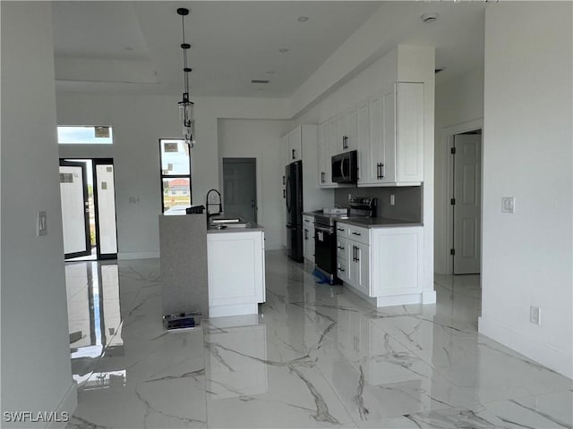 kitchen featuring appliances with stainless steel finishes, sink, hanging light fixtures, and white cabinets