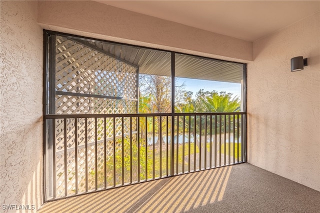 unfurnished sunroom featuring a water view