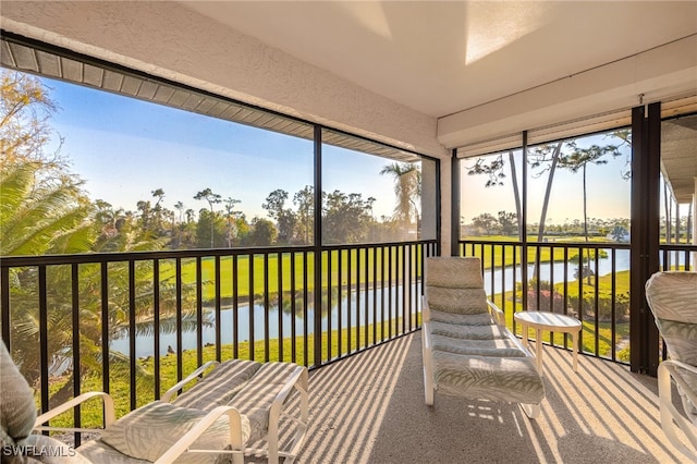 sunroom with a water view and a healthy amount of sunlight