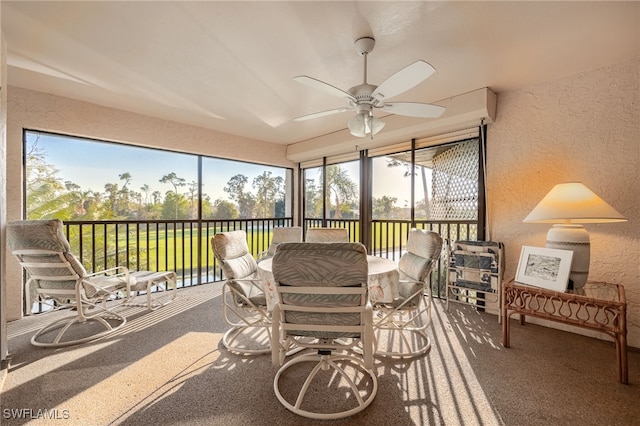 sunroom featuring ceiling fan