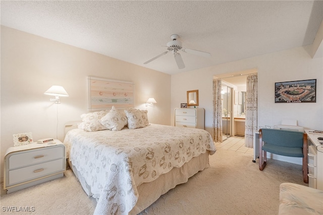 carpeted bedroom featuring ceiling fan, connected bathroom, and a textured ceiling