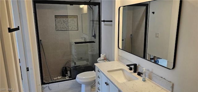 bathroom featuring toilet, vanity, and walk in shower