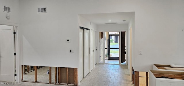 corridor with light hardwood / wood-style floors