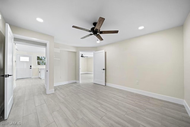 spare room featuring ceiling fan and light wood-type flooring