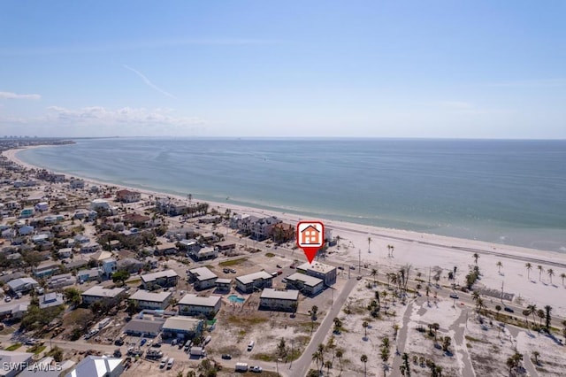 drone / aerial view featuring a water view and a beach view