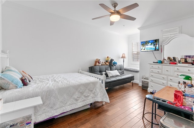 bedroom featuring dark wood-type flooring, crown molding, and ceiling fan