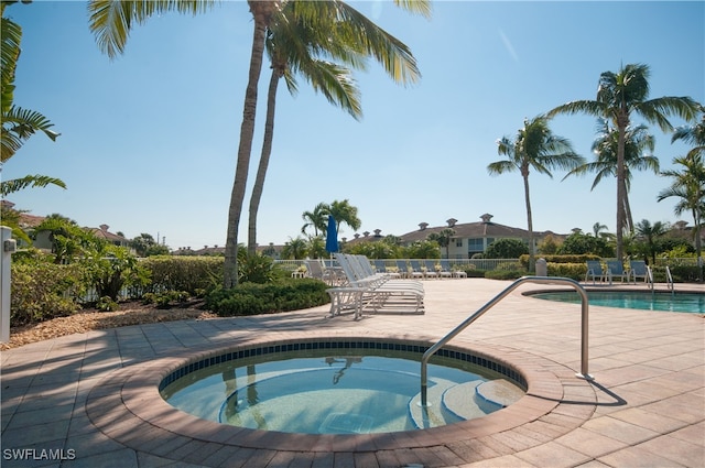 pool featuring a patio area and a hot tub