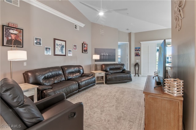 living area featuring light tile patterned floors, lofted ceiling, visible vents, and a ceiling fan