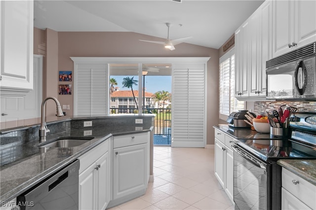 kitchen with lofted ceiling, a sink, white cabinets, black appliances, and dark stone countertops