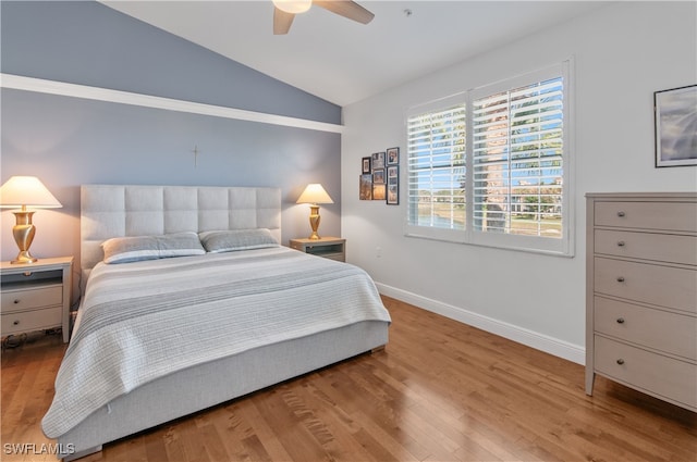 bedroom with lofted ceiling, ceiling fan, light wood-style flooring, and baseboards