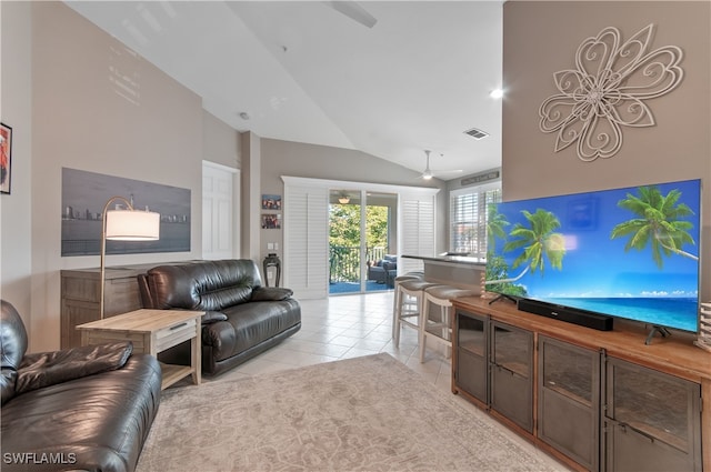 living room featuring lofted ceiling, light tile patterned floors, ceiling fan, and visible vents