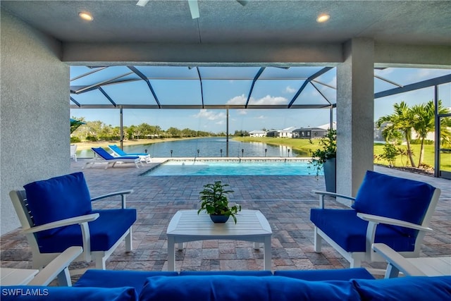 view of swimming pool featuring a patio, a water view, and a lanai