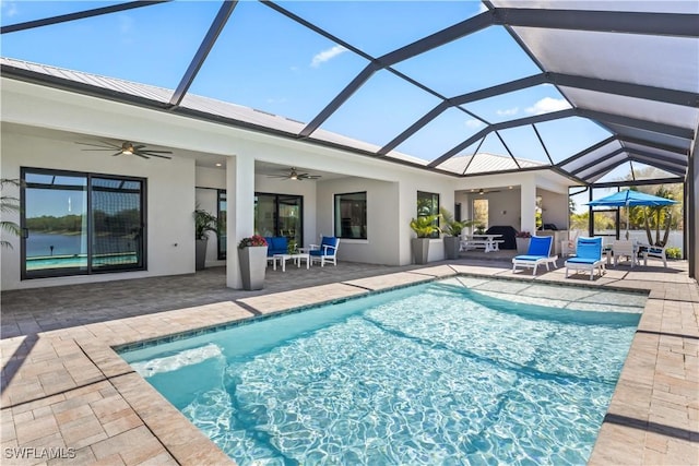 pool with a patio, a lanai, and a ceiling fan