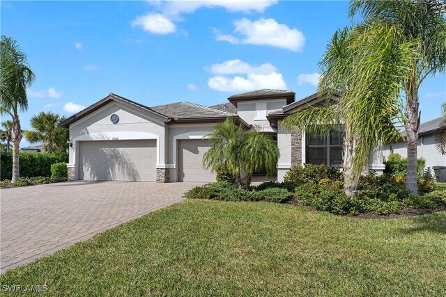 view of front of property featuring a front yard and a garage