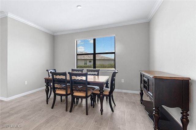 dining room featuring crown molding and light hardwood / wood-style floors