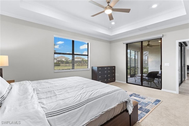 bedroom featuring multiple windows, a tray ceiling, and light colored carpet