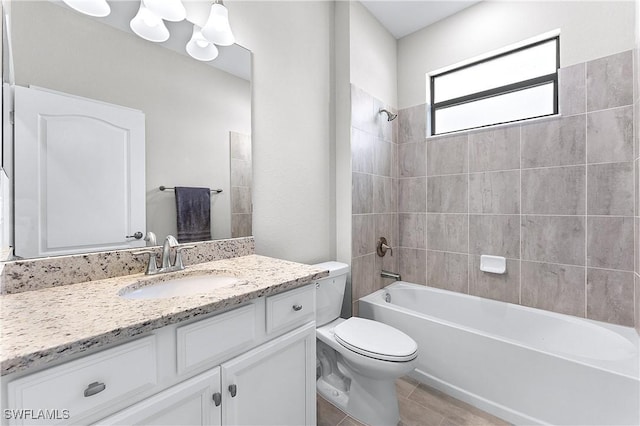 full bathroom with toilet, vanity, and tiled shower / bath