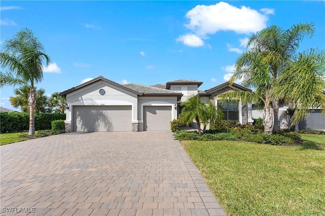 view of front of home with a front yard and a garage