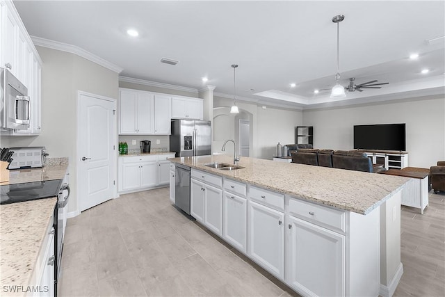 kitchen with a center island with sink, stainless steel appliances, white cabinets, and sink