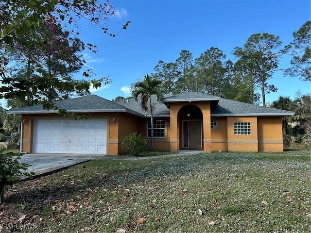 view of front of house with a garage and a front yard