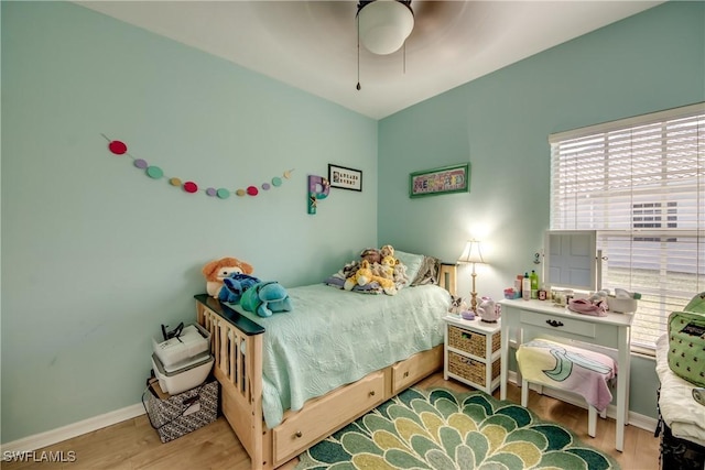 bedroom with light hardwood / wood-style flooring and ceiling fan