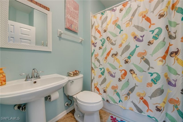 bathroom featuring sink, toilet, and tile patterned flooring