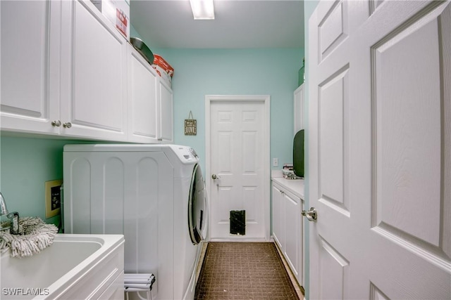 laundry room with cabinets, washer and clothes dryer, and sink