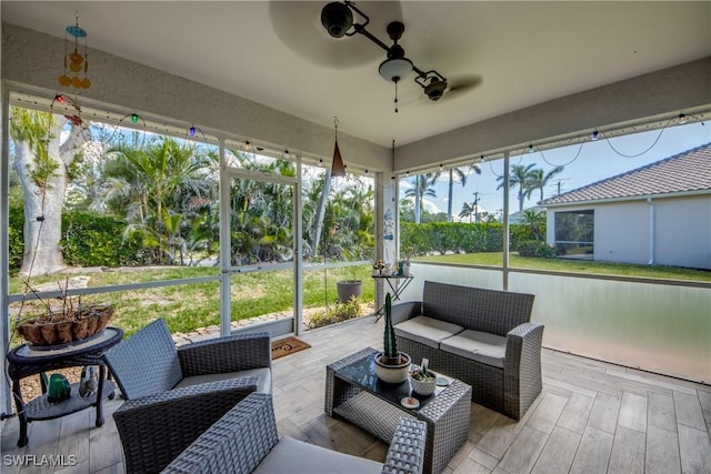 sunroom featuring ceiling fan