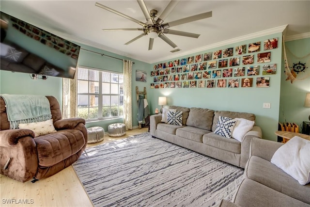 living room with crown molding, ceiling fan, and hardwood / wood-style floors