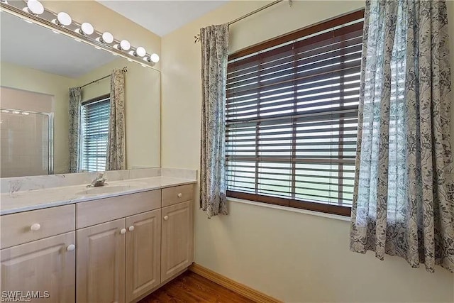 bathroom featuring hardwood / wood-style flooring, vanity, and plenty of natural light