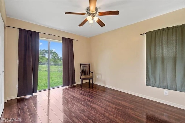 empty room featuring dark wood-type flooring and ceiling fan