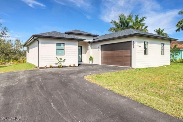 view of front of property featuring a garage and a front lawn