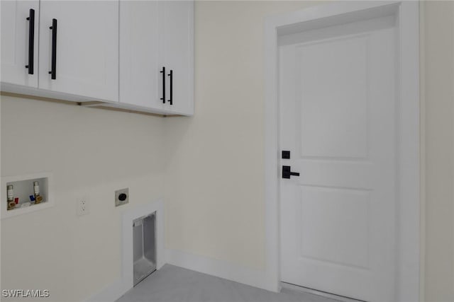 clothes washing area featuring washer hookup, electric dryer hookup, and cabinets