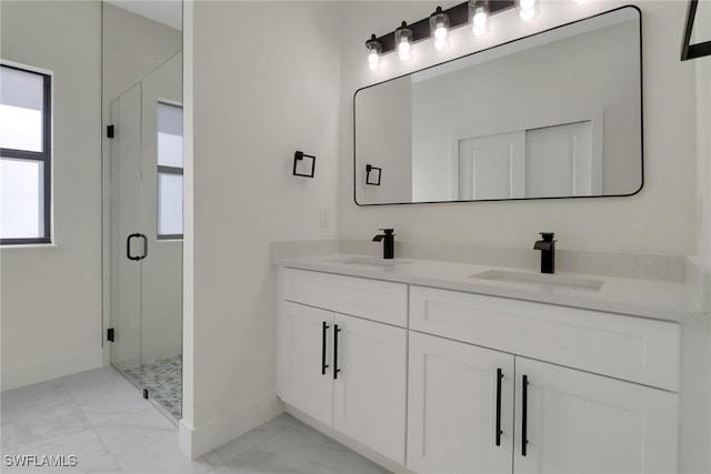 bathroom with vanity and a shower with door