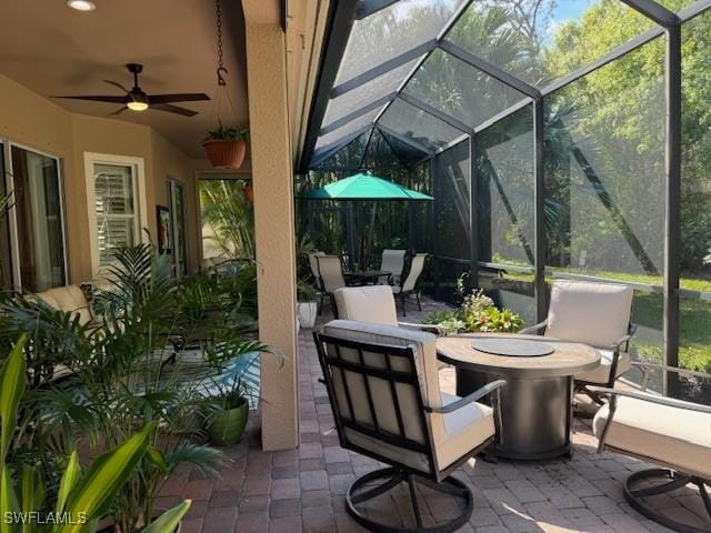 view of patio featuring a lanai and ceiling fan