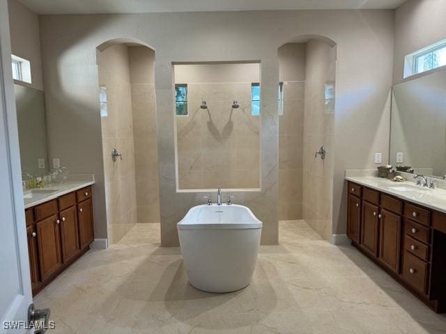 bathroom with vanity and independent shower and bath