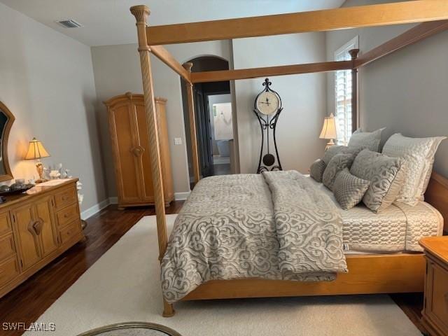 bedroom with dark wood-type flooring