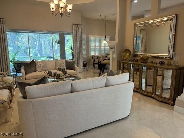 living room with a towering ceiling and an inviting chandelier