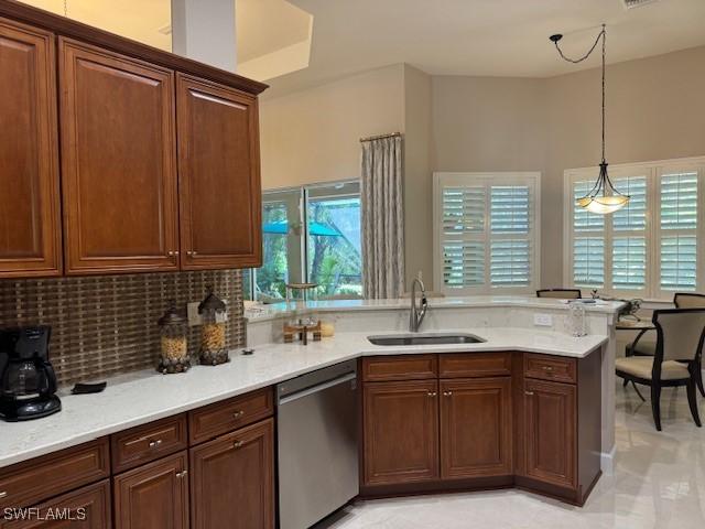 kitchen with dishwasher, sink, decorative backsplash, hanging light fixtures, and kitchen peninsula