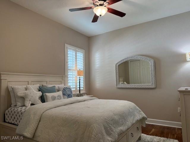 bedroom with dark hardwood / wood-style floors and ceiling fan